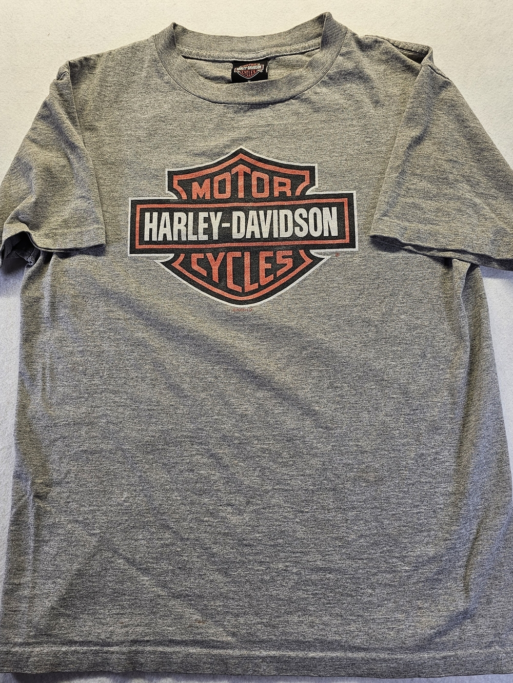 Vintage 2004 Harley-Davidson Gray T-Shirt with Orange and Black Shield Logo.